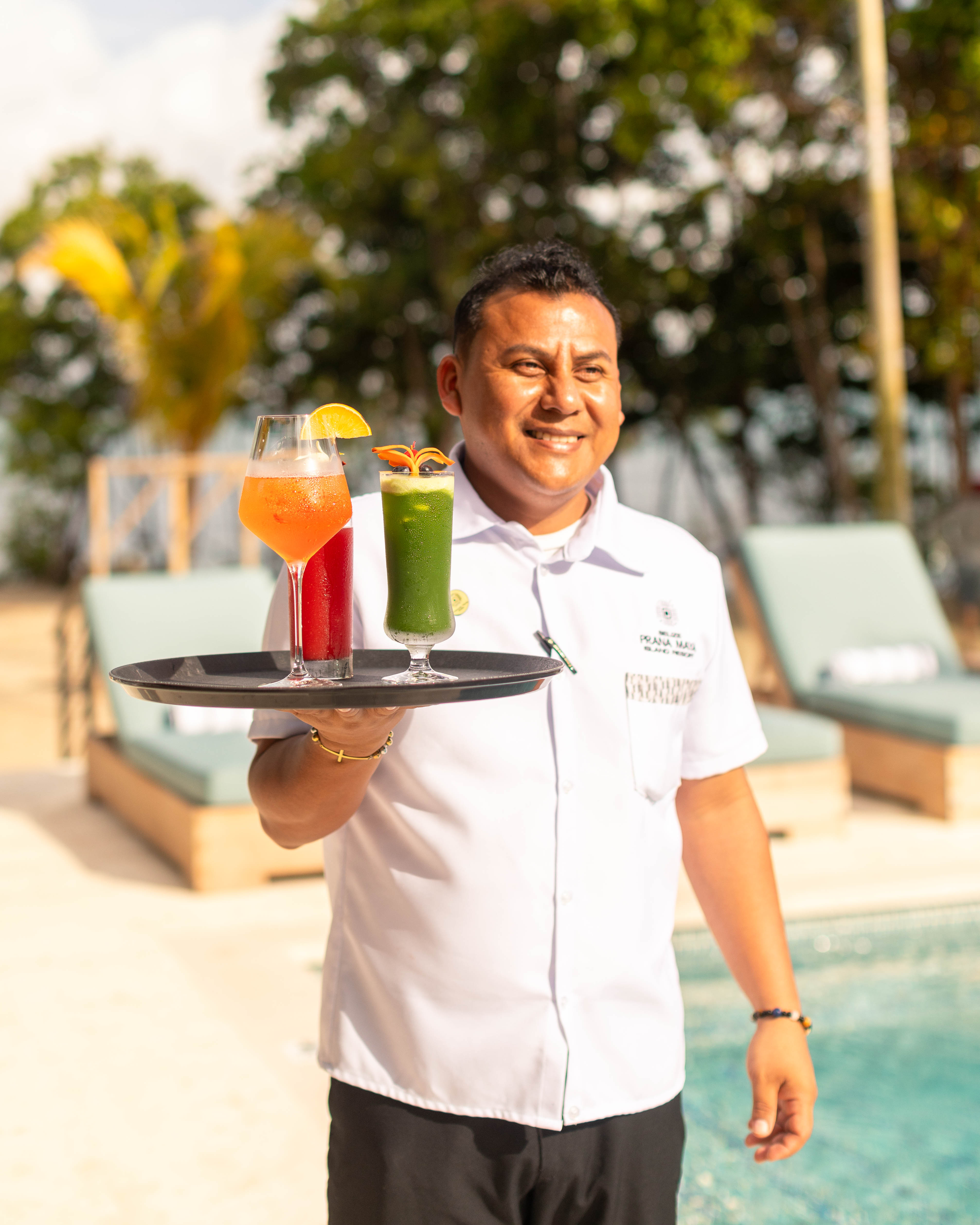 a man holding a tray with drinks
