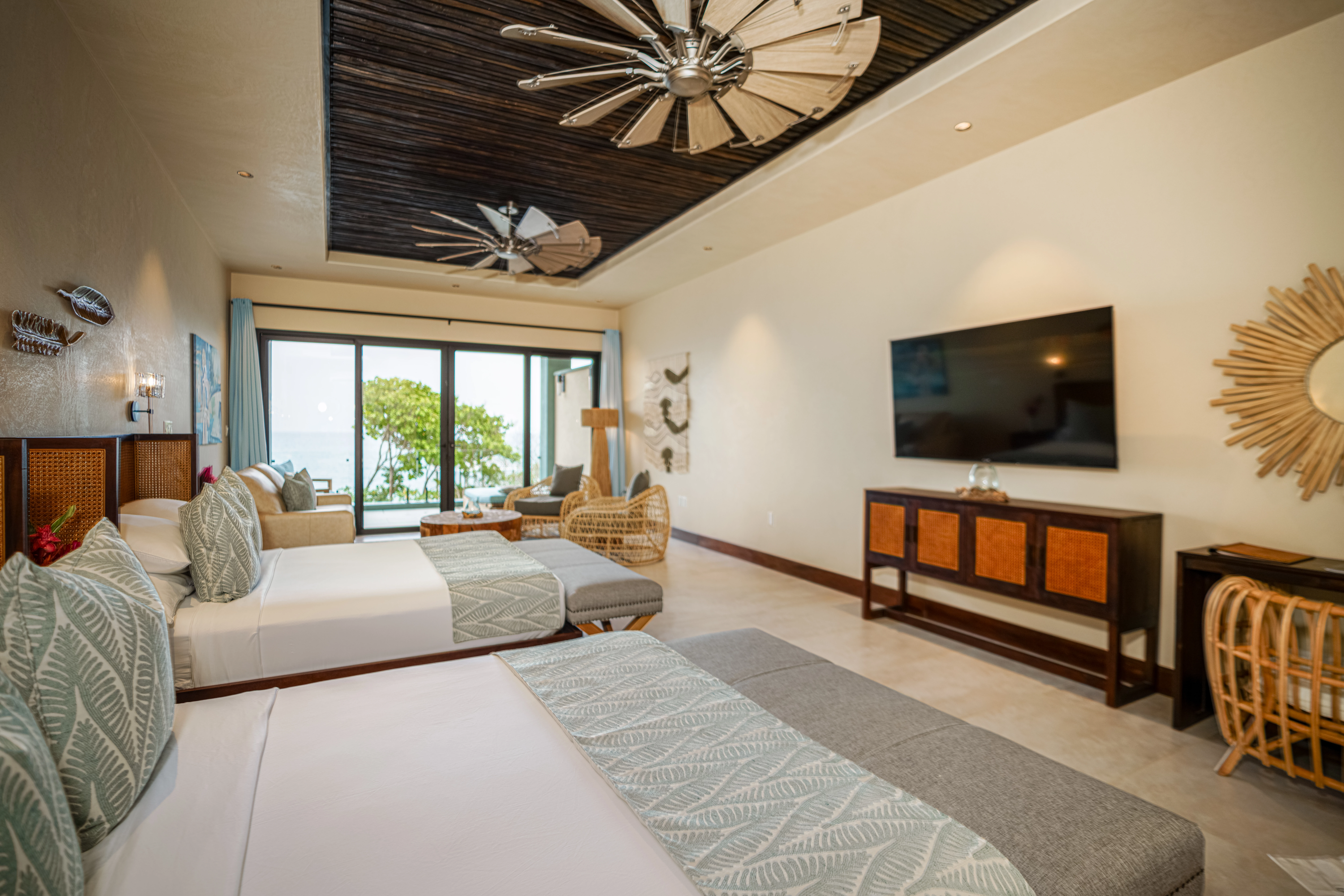 a room with two beds and a television