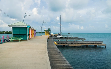 a dock with colorful buildings and boats on the water