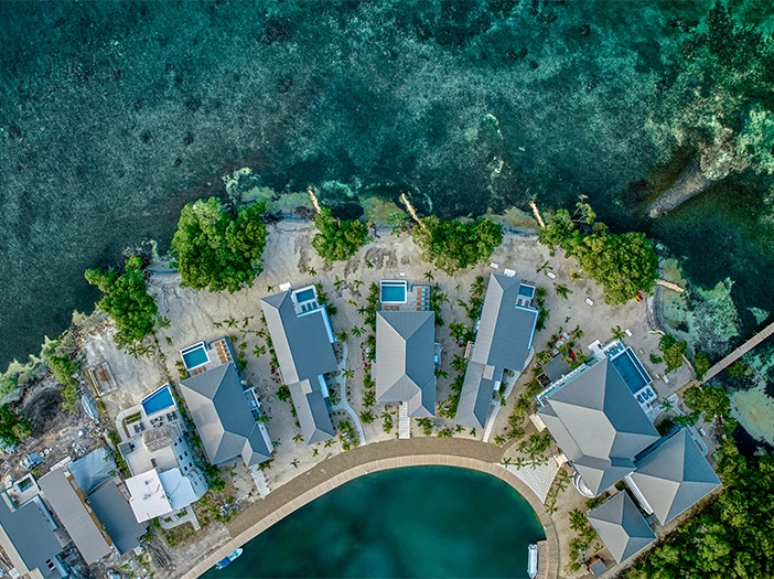 a group of houses next to a body of water