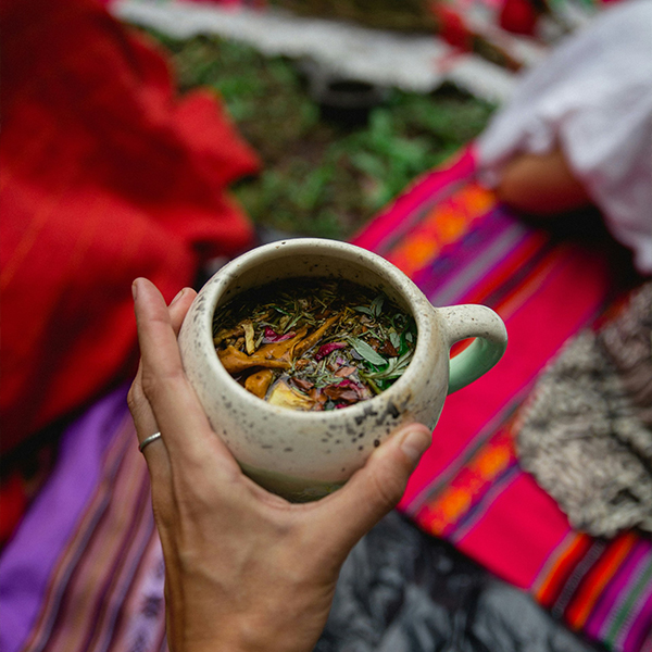 a person holding a cup of tea