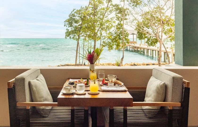 a table with food and drinks on it by a dock