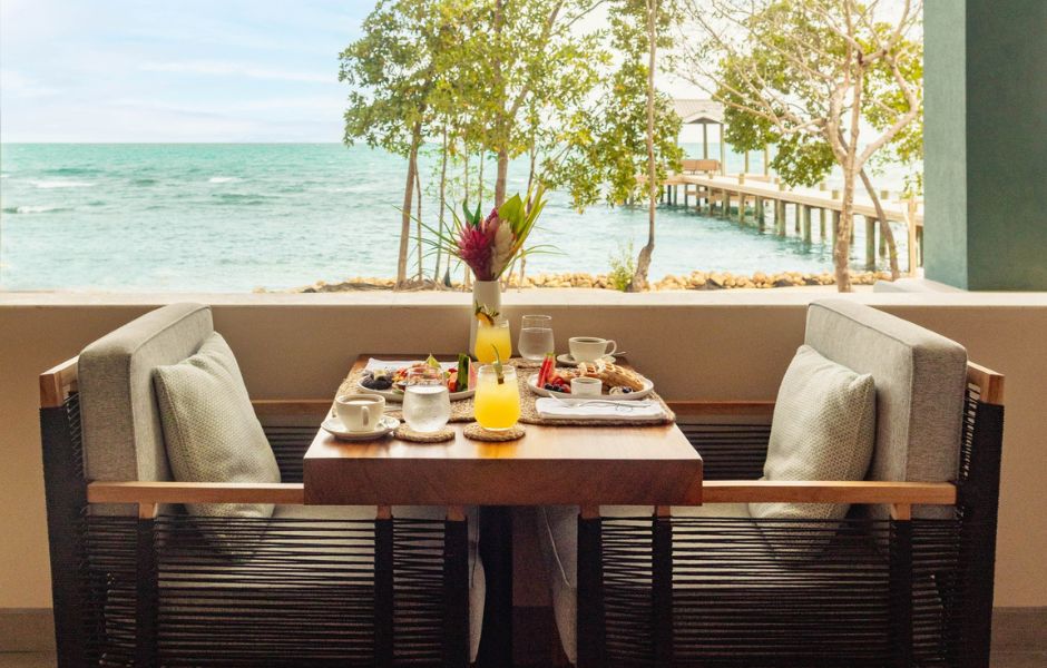 a table with food and drinks on it by a dock
