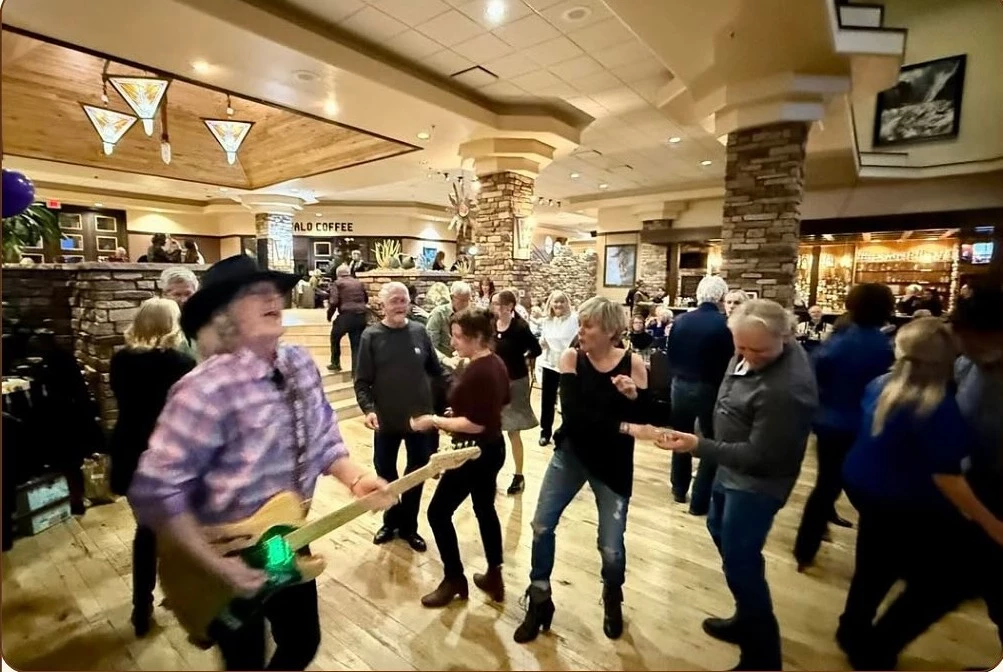 a group of people dancing in a room
