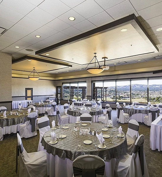 large meeting area with multiple round tables and chairs