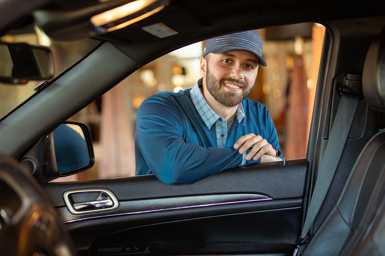 bellman leaning on a car door