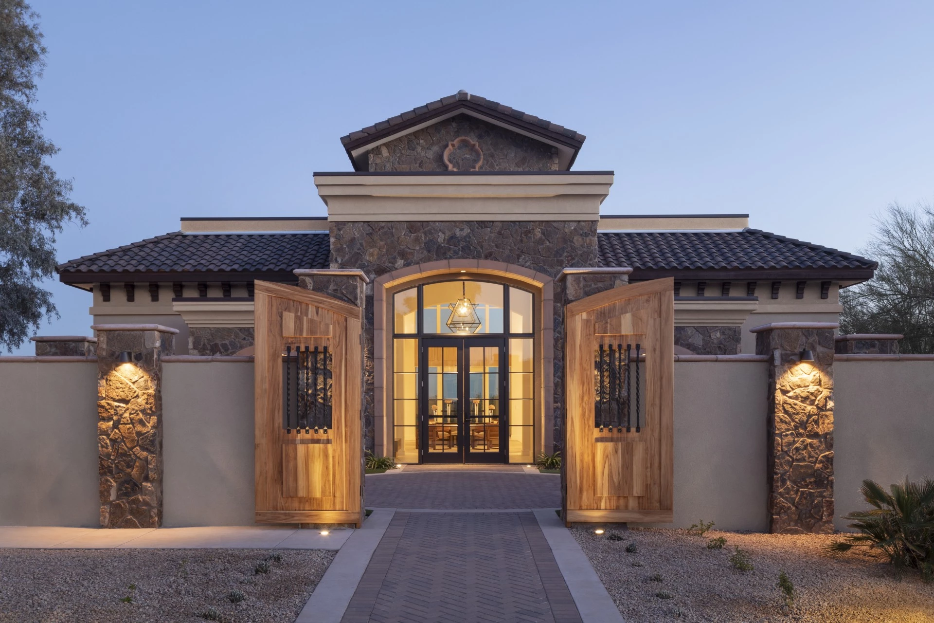 a building with a stone wall and a stone walkway