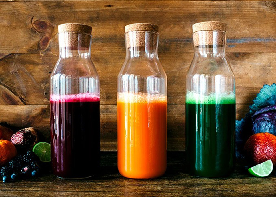 a group of bottles with different colored liquid
