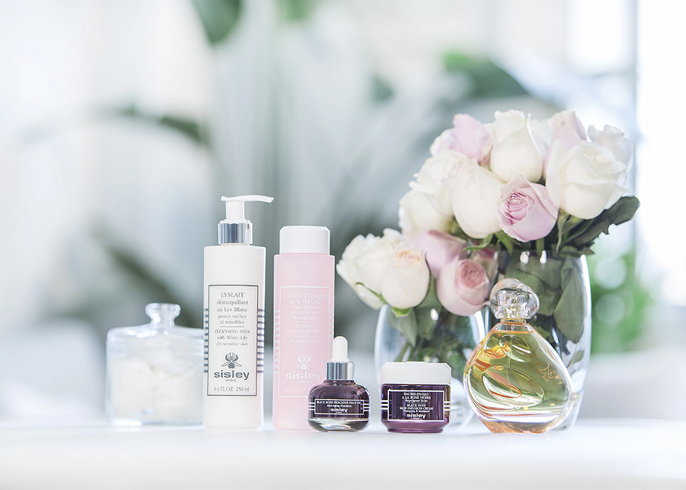 a group of bottles and a bouquet of roses