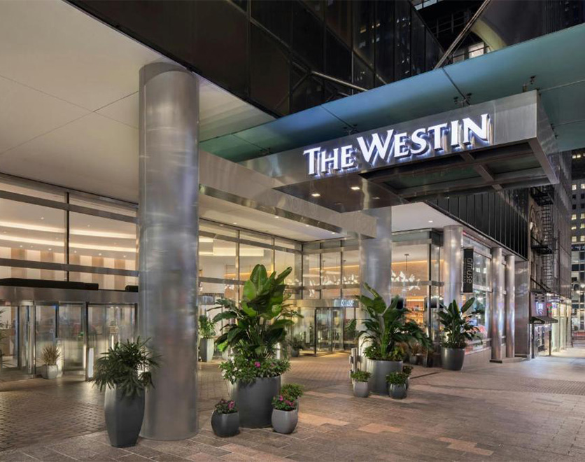 a building with glass doors and a sign