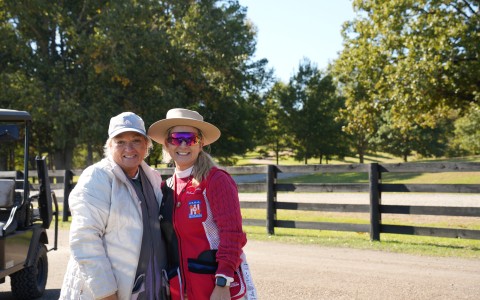 two women standing together outside