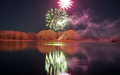 fireworks over a lake at night