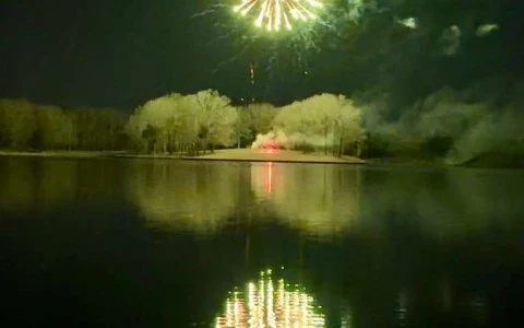 fireworks over a lake at night