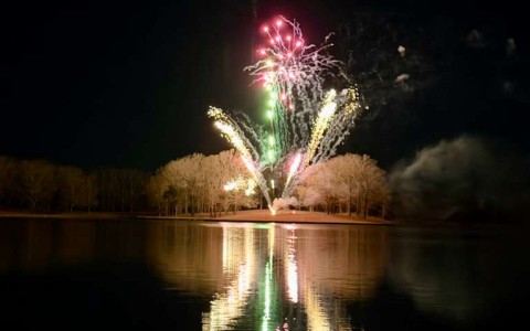 fireworks over a lake at night