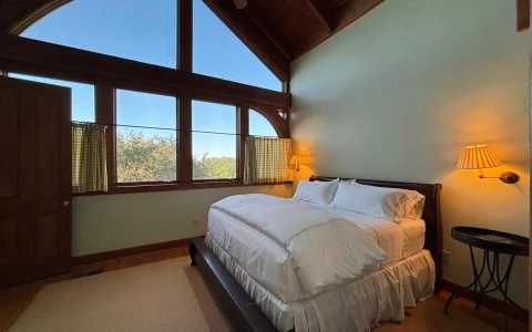 a bedroom with a large window
