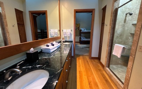 a bathroom with a large mirror and a sink