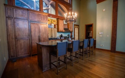 a kitchen with a bar and chairs