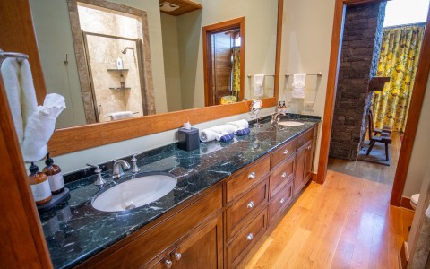 a bathroom with a large mirror and a large sink