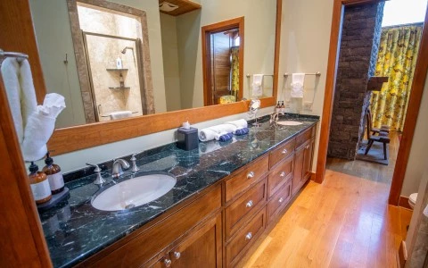 a bathroom with a large mirror and a large sink