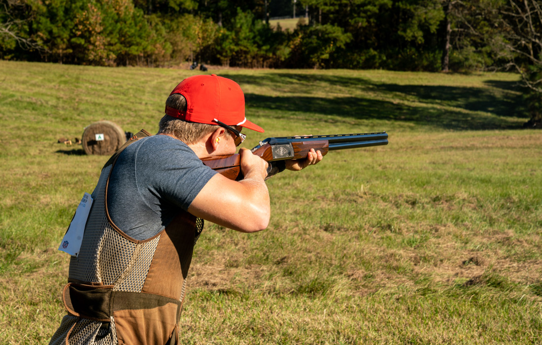 a person aiming a gun