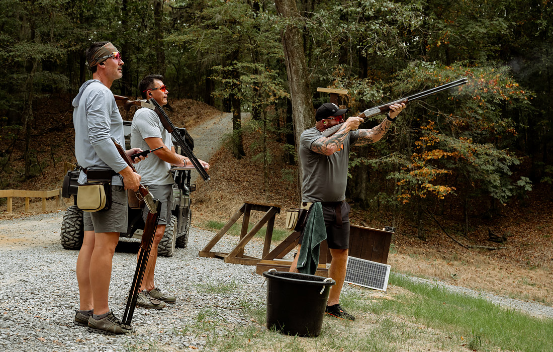 a group of men shooting a gun