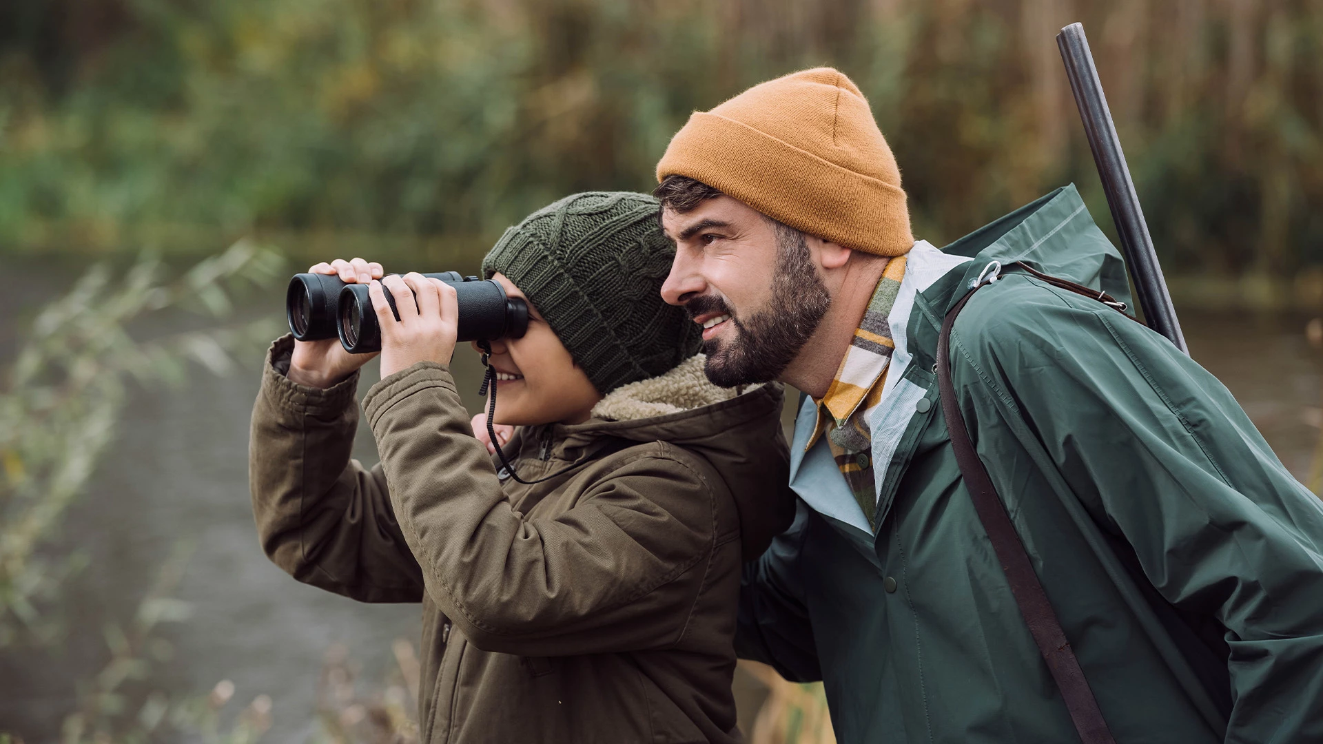 a couple of men looking through binoculars