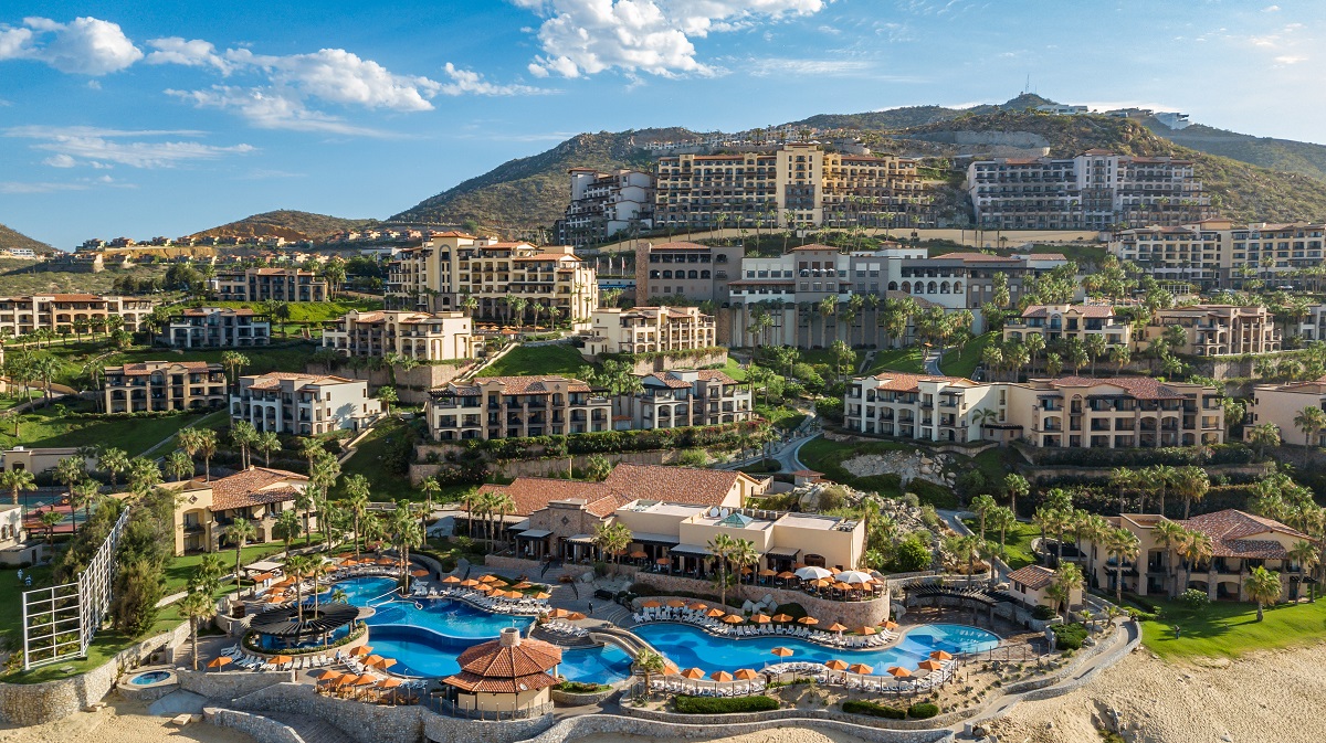 a resort with a pool and buildings