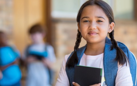a girl holding a book