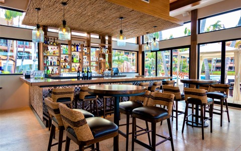 a bar with a counter and chairs