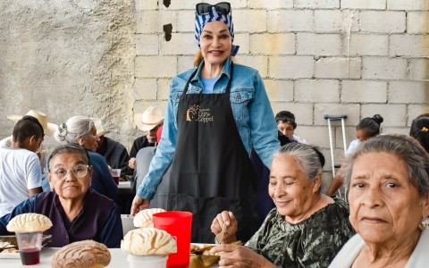 a woman standing in front of a group of people