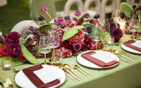 a table with flowers and glasses