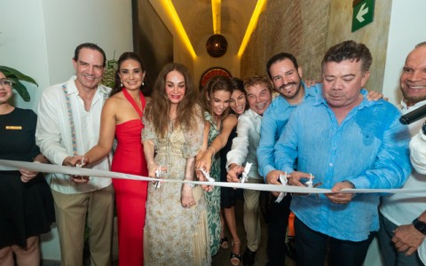 a group of people cutting a ribbon