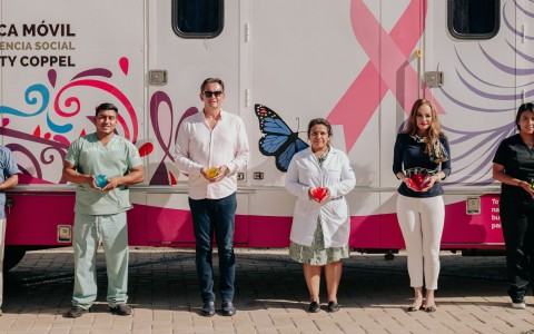 a group of people standing in front of a trailer