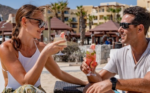 a man and woman holding drinks
