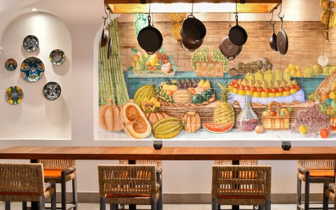 a table with chairs and a painting on the wall