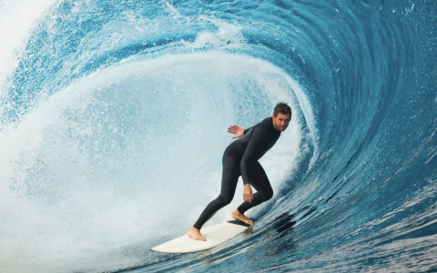 a man on a surfboard riding a wave