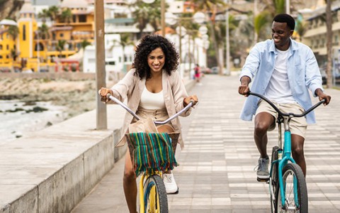 a man and woman riding bicycles