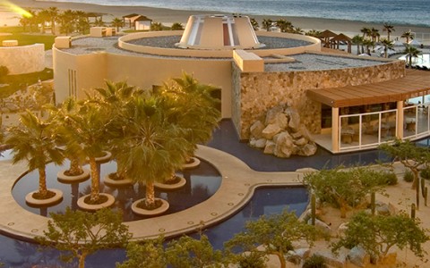 a building with a pool and trees