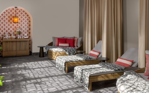 a room with wicker chairs and a couch