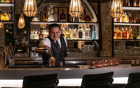 a man pouring a drink into a glass