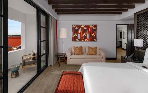 a bedroom with a couch and a painting on the wall