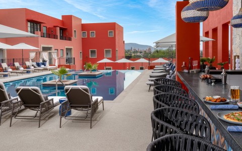 a pool with chairs and tables