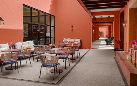 a patio with chairs and tables