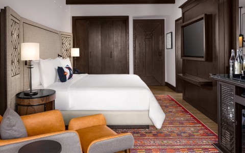 a room with a bed and a tv