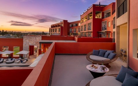 a patio with chairs and a table on it