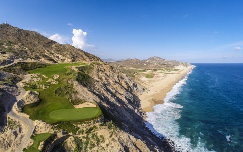 a golf course on a cliff by the ocean