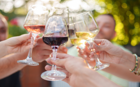 a group of people holding wine glasses