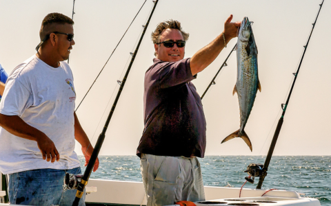 a man holding a fish