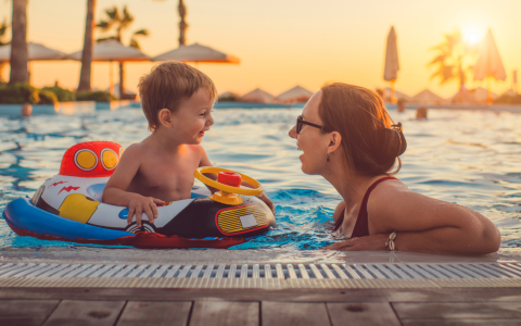 a woman and child in a pool