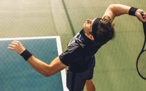 a man playing tennis on a court